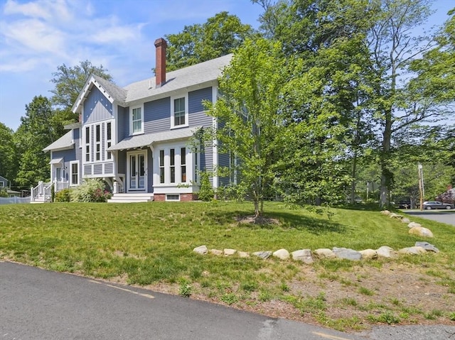 33 Grove St, Merrimac, MA 01860 - view of front of property featuring a chimney, a front yard, and board and batten siding