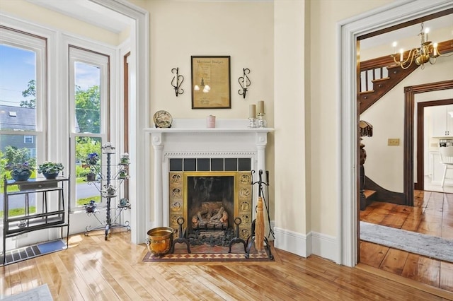 33 Grove St, Merrimac, MA 01860 - living area with a fireplace, wood-type flooring, and a chandelier