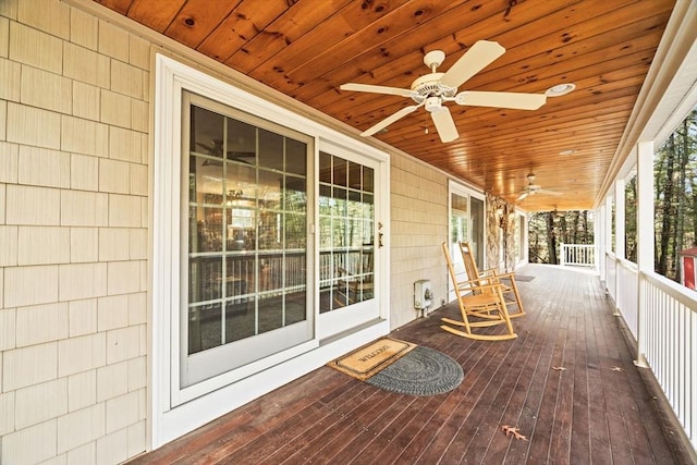 wooden deck with covered porch and ceiling fan