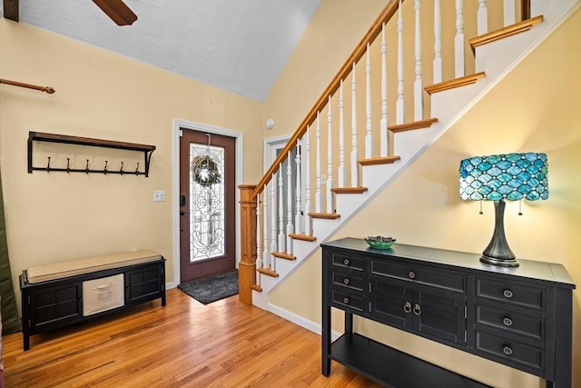 foyer with lofted ceiling and light wood-type flooring