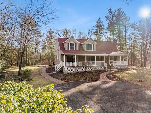 view of front of house with a front yard and a porch