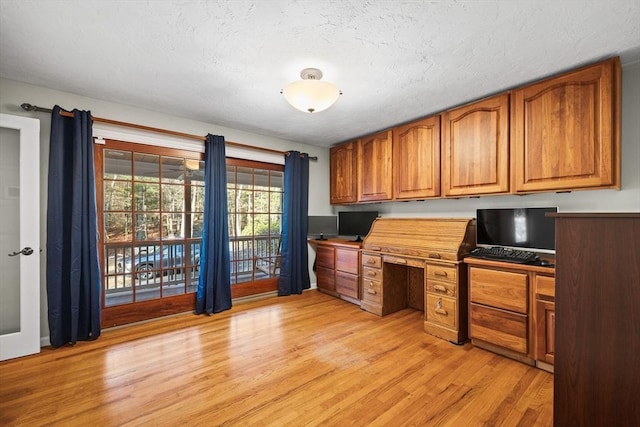 kitchen featuring light wood-type flooring and built in desk