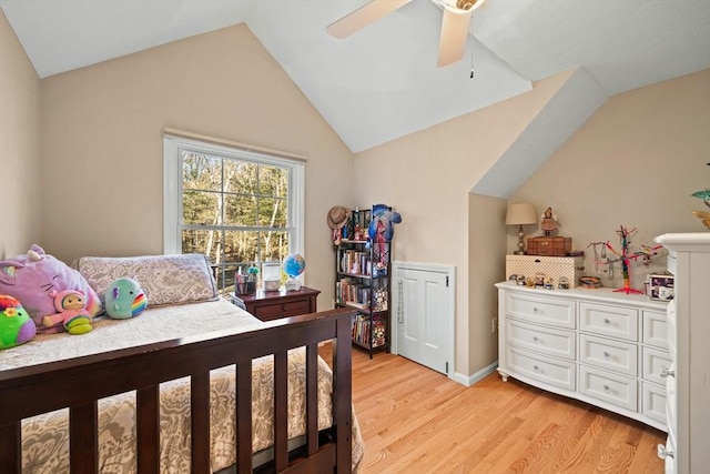 bedroom with ceiling fan, light hardwood / wood-style floors, and lofted ceiling