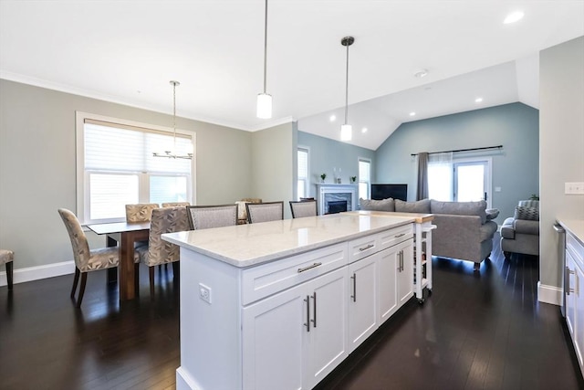 13 Birkdale Ln Unit 13, Hopkinton, MA 01748 - kitchen featuring dark wood finished floors, light stone counters, white cabinets, pendant lighting, and a center island