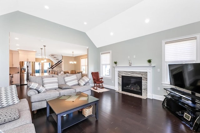 13 Birkdale Ln Unit 13, Hopkinton, MA 01748 - living area featuring vaulted ceiling, dark wood-style floors, baseboards, stairway, and a high end fireplace