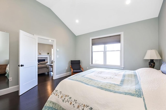 13 Birkdale Ln Unit 13, Hopkinton, MA 01748 - bedroom featuring baseboards, vaulted ceiling, dark wood finished floors, a fireplace, and recessed lighting
