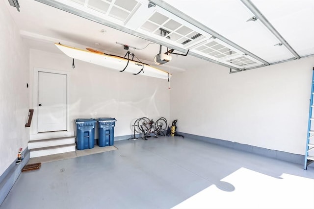 13 Birkdale Ln Unit 13, Hopkinton, MA 01748 - garage with a garage door opener and baseboards