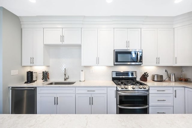 13 Birkdale Ln Unit 13, Hopkinton, MA 01748 - kitchen with appliances with stainless steel finishes, a sink, white cabinets, decorative backsplash, and recessed lighting