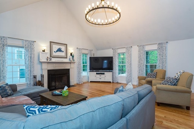 5 Lake Boon Dr, Hudson, MA 01749 - living area with high vaulted ceiling, a chandelier, light wood-style floors, plenty of natural light, and a fireplace with flush hearth