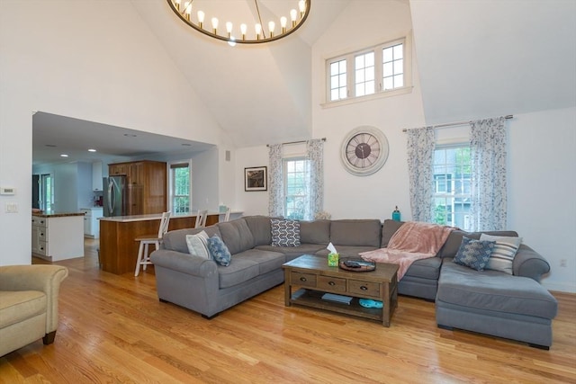 5 Lake Boon Dr, Hudson, MA 01749 - living room with high vaulted ceiling, light wood-type flooring, and a chandelier