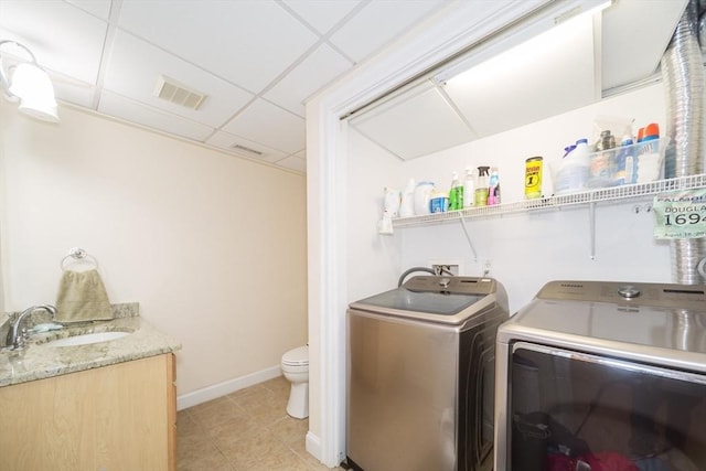 5 Lake Boon Dr, Hudson, MA 01749 - laundry area with washing machine and dryer, light tile patterned flooring, and baseboards