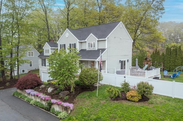 5 Lake Boon Dr, Hudson, MA 01749 - view of front of property with roof with shingles, an attached garage, a chimney, and view of scattered trees