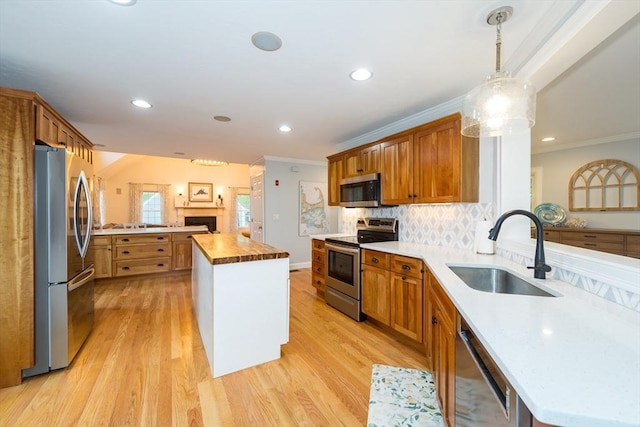 5 Lake Boon Dr, Hudson, MA 01749 - kitchen featuring stainless steel appliances, a sink, a peninsula, light wood-style floors, and tasteful backsplash