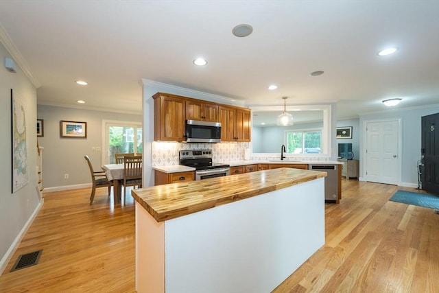 5 Lake Boon Dr, Hudson, MA 01749 - kitchen with appliances with stainless steel finishes, wooden counters, a sink, ornamental molding, and light wood-type flooring