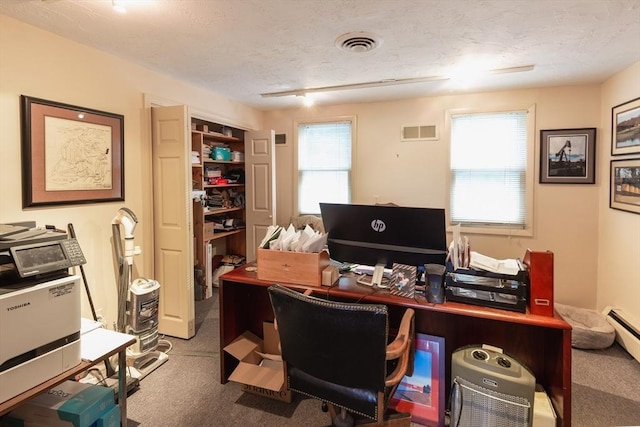 office space with carpet flooring and a textured ceiling