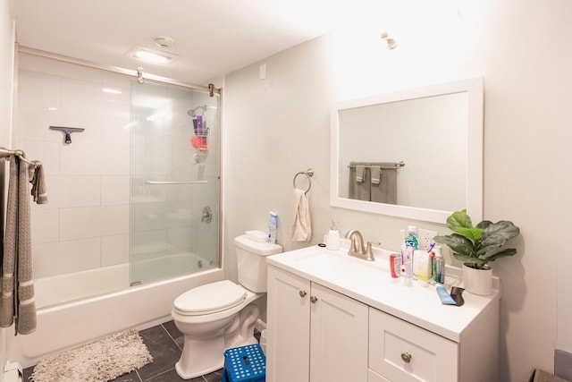 full bathroom featuring vanity, tile patterned floors, enclosed tub / shower combo, and toilet