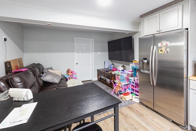 kitchen with white cabinetry, light hardwood / wood-style flooring, and stainless steel fridge with ice dispenser