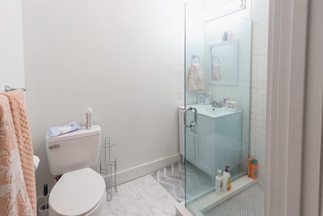 bathroom featuring a shower, vanity, and toilet