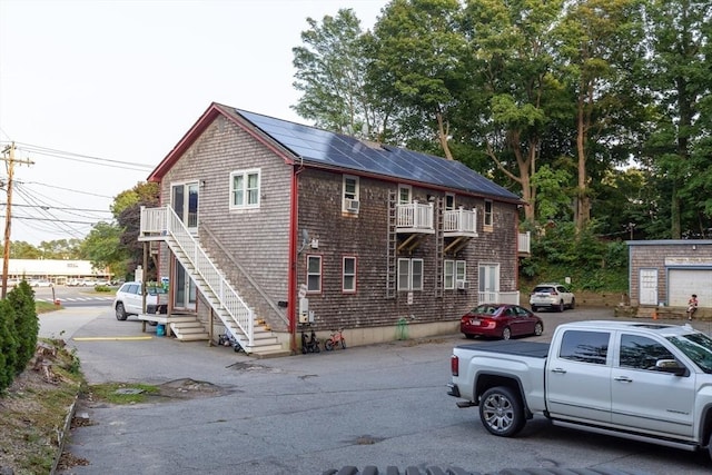 view of front of property featuring solar panels