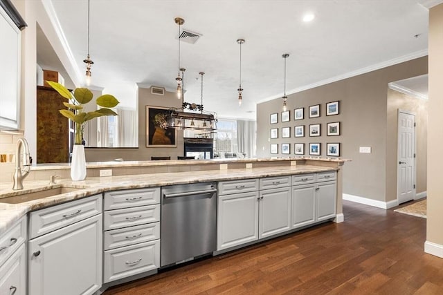 kitchen with crown molding, white cabinetry, a sink, and visible vents