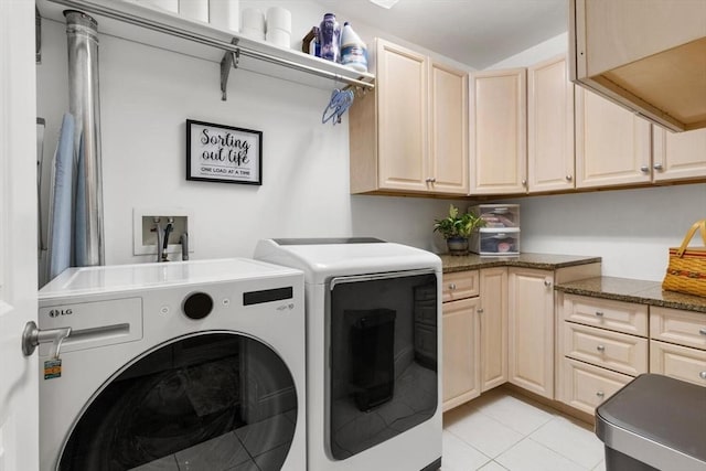 laundry room featuring cabinet space, washer and clothes dryer, and light tile patterned flooring