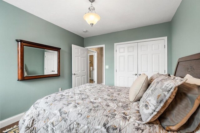 bedroom with baseboards and a closet