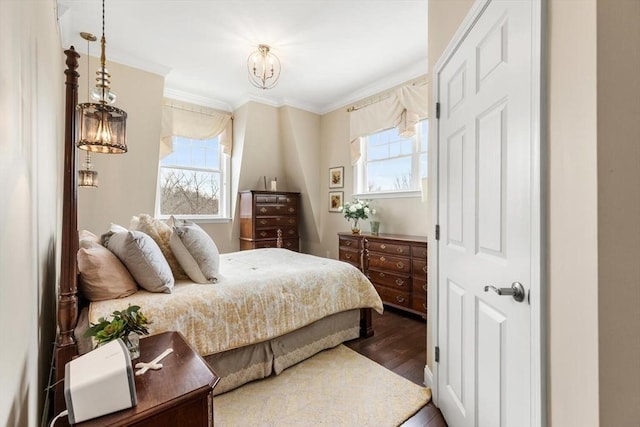 bedroom with multiple windows, dark wood finished floors, and crown molding