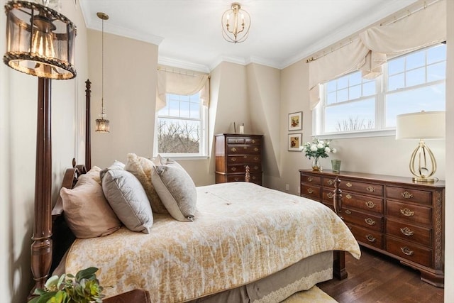 bedroom with ornamental molding, dark wood-style flooring, and a notable chandelier