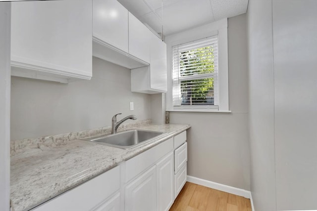 6-8 Carlton, Lynn, MA 01902 - kitchen featuring a sink, light countertops, white cabinets, and light wood finished floors