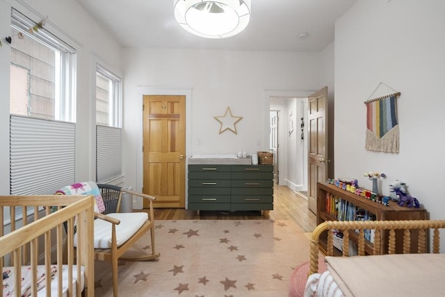 414 Sumner St Unit 1, Boston, MA 02128 - bedroom featuring light wood-style flooring and a nursery area