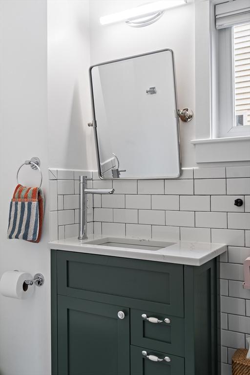 414 Sumner St Unit 1, Boston, MA 02128 - bathroom with vanity and tasteful backsplash