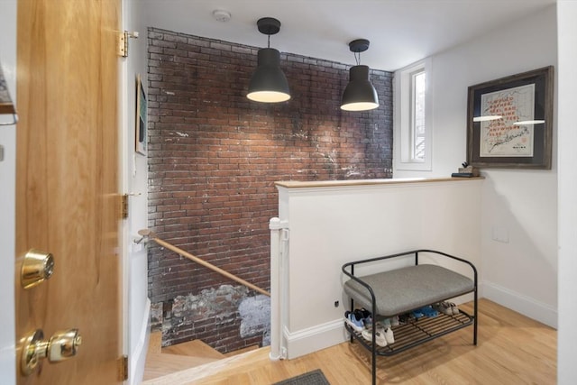 414 Sumner St Unit 1, Boston, MA 02128 - detailed view of brick wall, baseboards, a smoke detector, and wood finished floors
