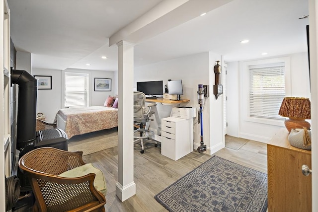 414 Sumner St Unit 1, Boston, MA 02128 - bedroom with multiple windows, light wood-style flooring, baseboards, decorative columns, and recessed lighting