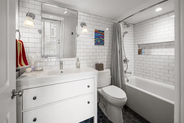 414 Sumner St Unit 1, Boston, MA 02128 - full bath featuring toilet, vanity, shower / bath combo with shower curtain, tile patterned flooring, and tile walls