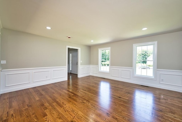 526 Old Warren Rd, Swansea, MA 02777 - spare room with wainscoting, dark wood-style flooring, a decorative wall, and recessed lighting