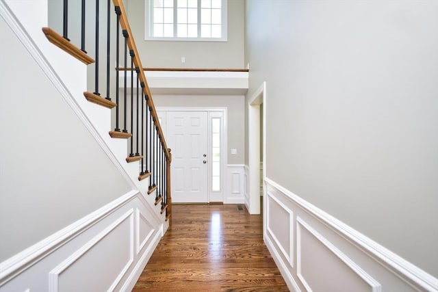 526 Old Warren Rd, Swansea, MA 02777 - foyer entrance featuring a decorative wall, a wainscoted wall, dark wood-style floors, stairway, and a towering ceiling