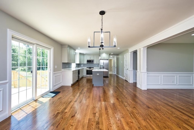 526 Old Warren Rd, Swansea, MA 02777 - kitchen featuring stainless steel appliances, light countertops, a chandelier, gray cabinetry, and a decorative wall