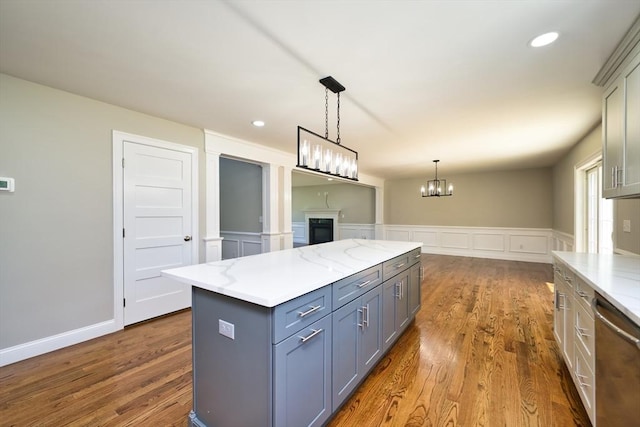 526 Old Warren Rd, Swansea, MA 02777 - kitchen featuring stainless steel dishwasher, a decorative wall, gray cabinetry, dark wood-style floors, and a center island