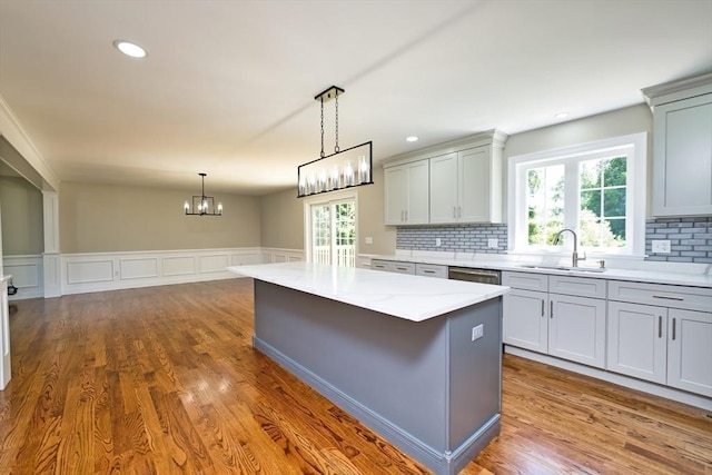 526 Old Warren Rd, Swansea, MA 02777 - kitchen featuring decorative backsplash, dark wood finished floors, hanging light fixtures, a chandelier, and wainscoting