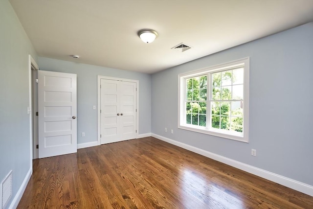 526 Old Warren Rd, Swansea, MA 02777 - unfurnished bedroom featuring dark wood-style flooring and a closet