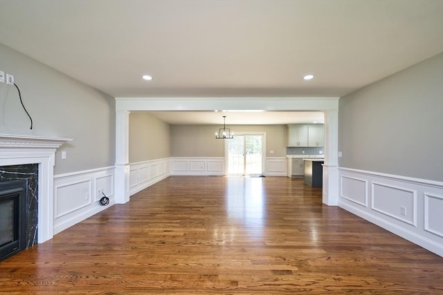 526 Old Warren Rd, Swansea, MA 02777 - unfurnished living room featuring a high end fireplace, a decorative wall, dark wood-style flooring, wainscoting, and recessed lighting