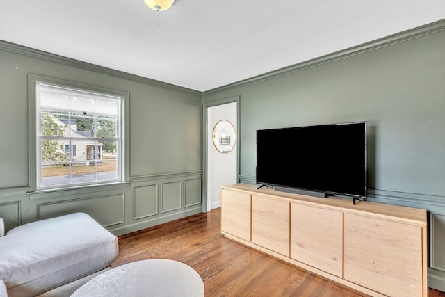 living room with ornamental molding and hardwood / wood-style flooring