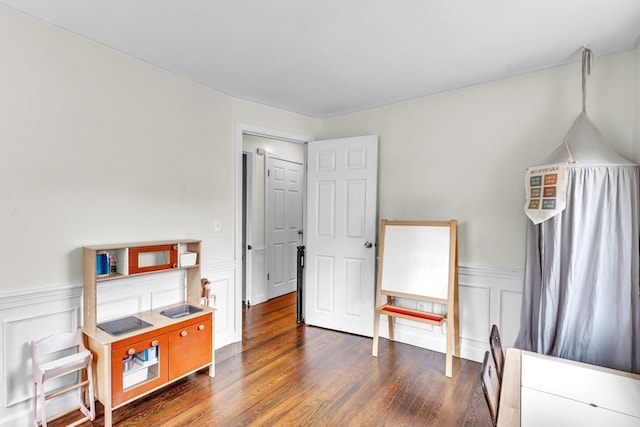 miscellaneous room featuring dark wood-type flooring