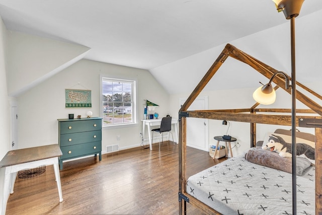 bedroom featuring lofted ceiling and dark wood-type flooring