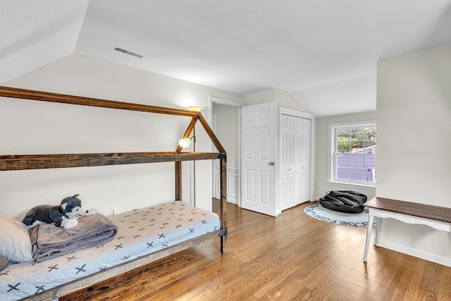 bedroom featuring vaulted ceiling and hardwood / wood-style floors