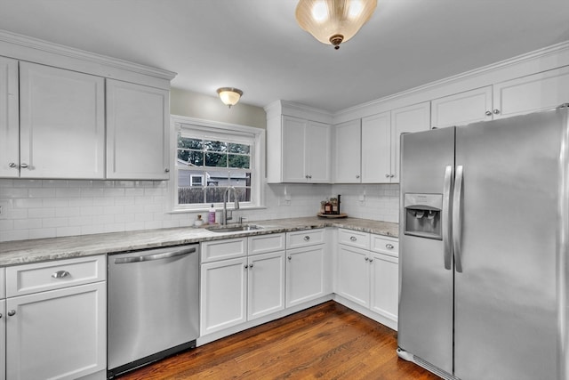 kitchen with dark hardwood / wood-style flooring, stainless steel appliances, white cabinetry, and sink