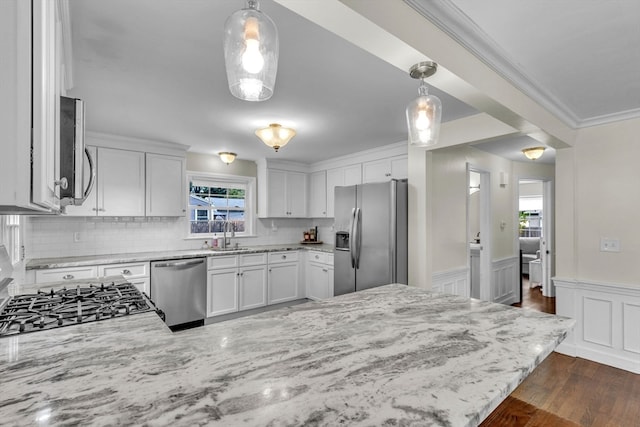 kitchen with pendant lighting, dark wood-type flooring, white cabinetry, kitchen peninsula, and stainless steel appliances