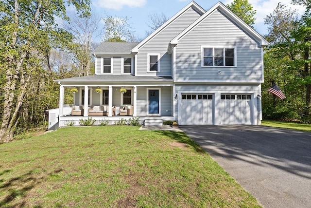view of front facade featuring an attached garage, aphalt driveway, covered porch, and a front yard