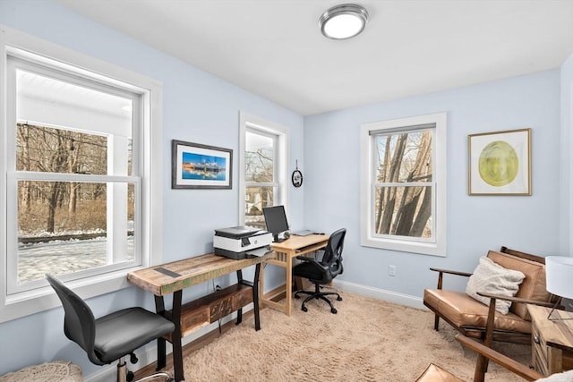office area featuring baseboards and light colored carpet