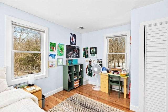 bedroom featuring baseboards, visible vents, and light wood-style floors